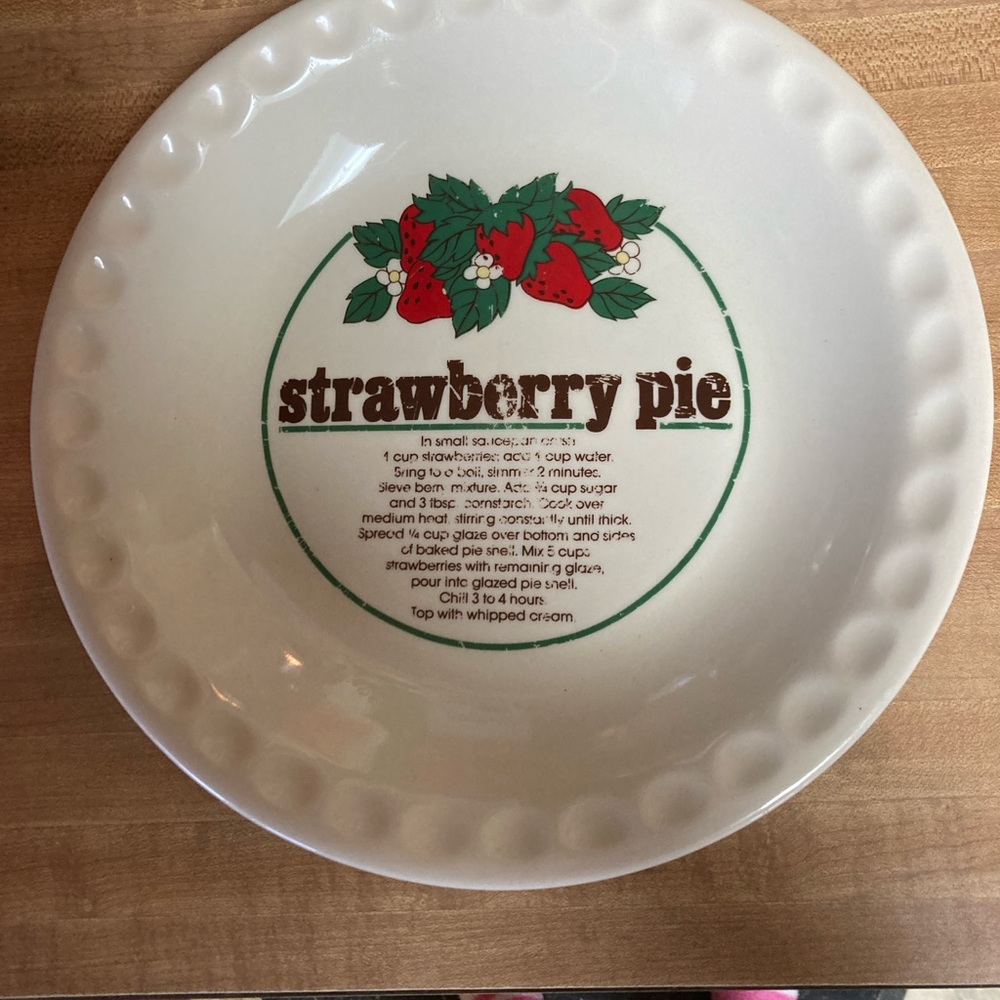 Strawberry pie plate with the recipe on the plate it’s a little worn on words